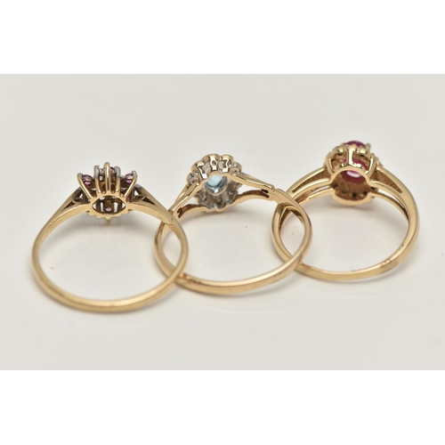 34 - THREE 9CT GOLD GEM SET RINGS, to include a topaz and diamond cluster, ring size O, a ruby and diamon... 