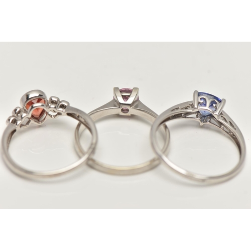 35 - THREE 9CT WHITE GOLD GEM SET RINGS, to include a garnet and diamond ring, ring size N, a tanzanite a... 