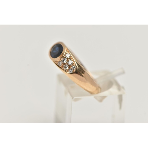 48 - A YELLOW METAL SAPPHIRE AND DIAMOND RING, designed with a central oval cut deep blue sapphire, flank... 