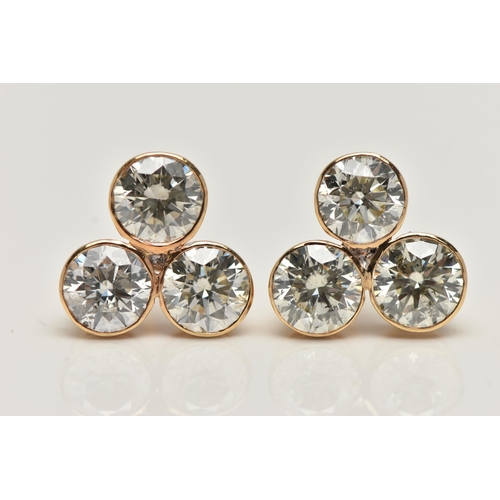 5 - A PAIR OF 6 CARAT DIAMOND STUD EARRINGS, each earring comprising of three round brilliant cut diamon... 