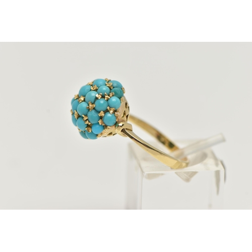 56 - A YELLOW METAL TURQUOISE DOME RING, circular dome set with turquoise cabochons, raised on an open wo... 