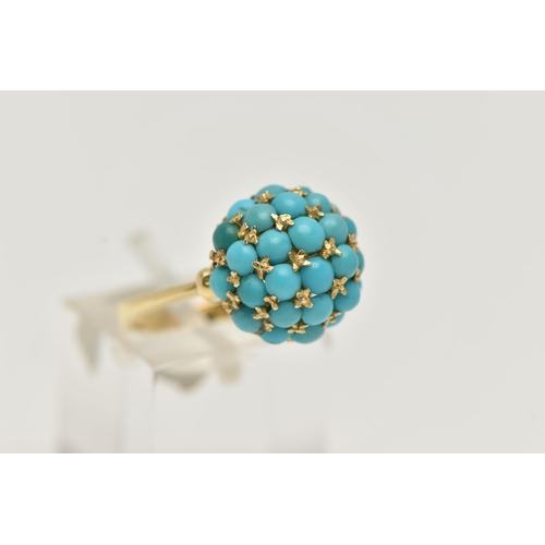 56 - A YELLOW METAL TURQUOISE DOME RING, circular dome set with turquoise cabochons, raised on an open wo... 