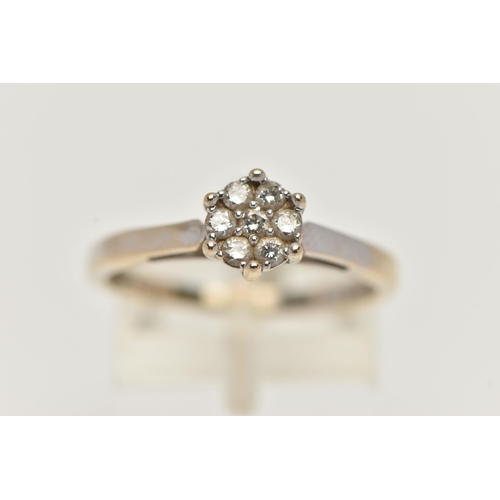 89 - A WHITE GOLD DIAMOND CLUSTER RING, small cluster of seven round brilliant cut diamonds, stamped diam... 