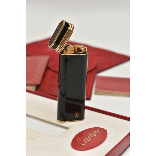 144 - A 'MUST DE CARTIER' LIGHTER, gilt lighter with black lacquer and trinity band, serial 28008T, with a... 