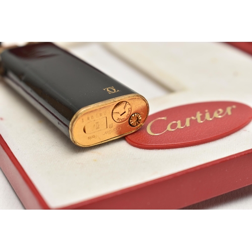 144 - A 'MUST DE CARTIER' LIGHTER, gilt lighter with black lacquer and trinity band, serial 28008T, with a... 