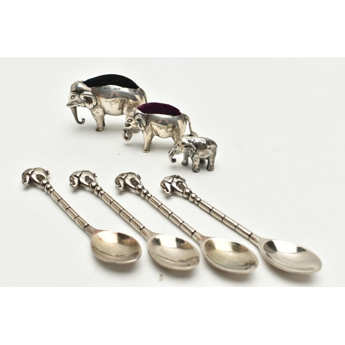 196 - AN EDWARDIAN SILVER ELEPHANT PIN CUSHION, TWO OTHERS AND FOUR SPOONS, realistically stylised elephan... 