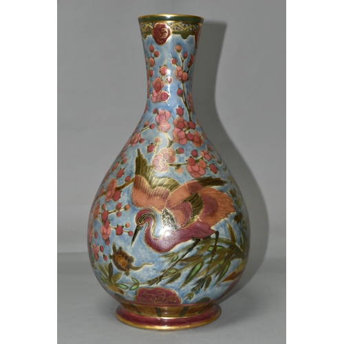 368 - AN ORIENTAL VASE, decorated with pink cranes and blossom on a pale blue ground, outlined in gold gil... 