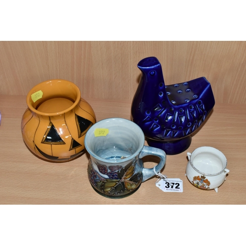 372 - A GROUP OF MOORCROFT POTTERY, comprising a 'Bramble' design mug (cracked and crazed), a Pumpkin vase... 