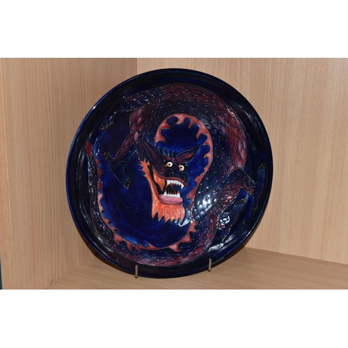 378 - A MOORCROFT DRAGON BOWL, designed by Trevor Critchlow for Moorcroft, a bowl decorated with a red and... 