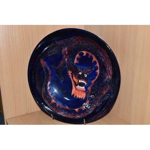 378 - A MOORCROFT DRAGON BOWL, designed by Trevor Critchlow for Moorcroft, a bowl decorated with a red and... 