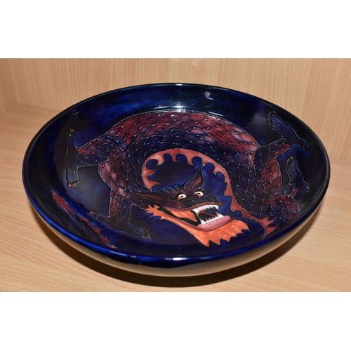 378 - A MOORCROFT DRAGON BOWL, designed by Trevor Critchlow for Moorcroft, a bowl decorated with a red and... 