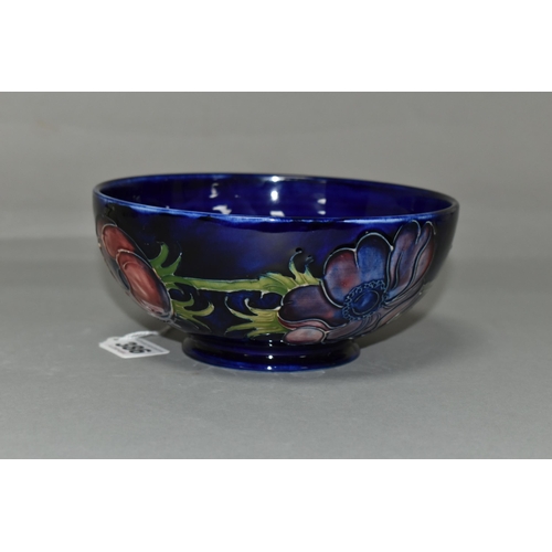 386 - A MOORCROFT POTTERY 'ANEMONE' BOWL, tube lined with red and purple anemones on a dark blue ground, p... 