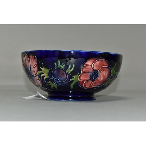 386 - A MOORCROFT POTTERY 'ANEMONE' BOWL, tube lined with red and purple anemones on a dark blue ground, p... 