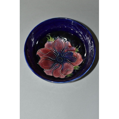 386 - A MOORCROFT POTTERY 'ANEMONE' BOWL, tube lined with red and purple anemones on a dark blue ground, p... 