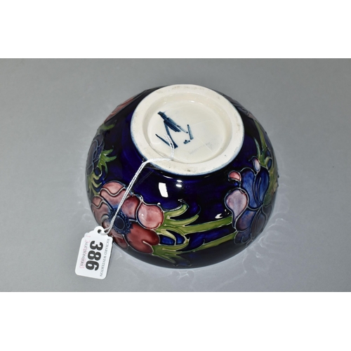 386 - A MOORCROFT POTTERY 'ANEMONE' BOWL, tube lined with red and purple anemones on a dark blue ground, p... 