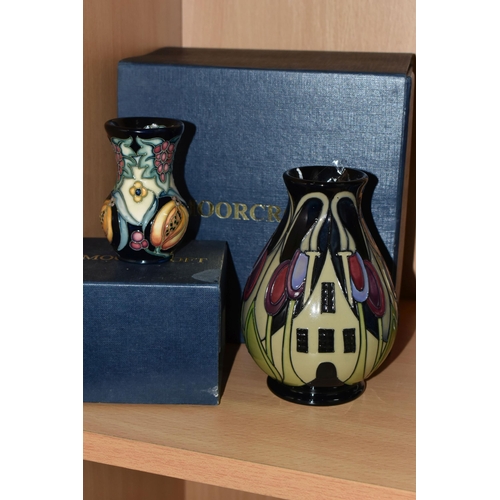 388 - TWO BOXED MOORCROFT POTTERY VASES, comprising a The Hamlet pattern baluster vase, tube lined with st... 