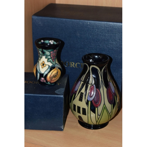 388 - TWO BOXED MOORCROFT POTTERY VASES, comprising a The Hamlet pattern baluster vase, tube lined with st... 