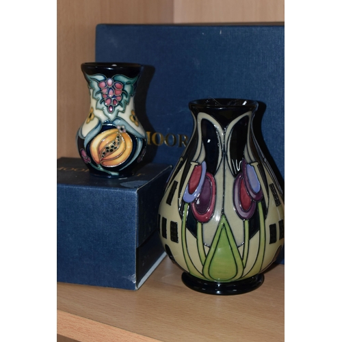 388 - TWO BOXED MOORCROFT POTTERY VASES, comprising a The Hamlet pattern baluster vase, tube lined with st... 