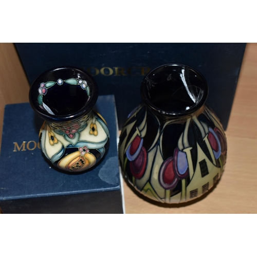 388 - TWO BOXED MOORCROFT POTTERY VASES, comprising a The Hamlet pattern baluster vase, tube lined with st... 