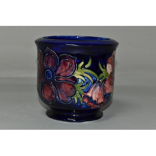 392 - A MOORCROFT POTTERY FOOTED JARDINIERE, tube lined in Anemone pattern on a dark blue ground, painted ... 