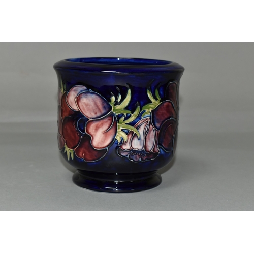 392 - A MOORCROFT POTTERY FOOTED JARDINIERE, tube lined in Anemone pattern on a dark blue ground, painted ... 