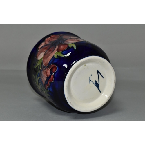 392 - A MOORCROFT POTTERY FOOTED JARDINIERE, tube lined in Anemone pattern on a dark blue ground, painted ... 