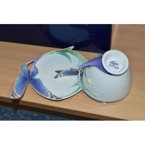 394 - A BOXED FRANZ PORCELAIN TEACUP AND SAUCER, in the Blue Butterfly pattern FZ00056 (2 + box) (Conditio... 