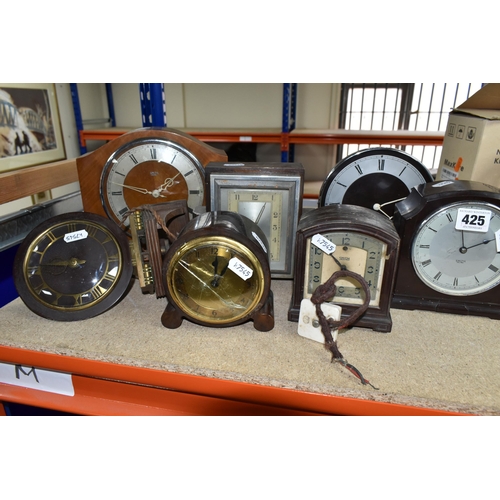 425 - A GROUP OF CLOCKS, comprising four 1930's Smith Sectric clocks, a Temco Bakelite electric clock by T... 