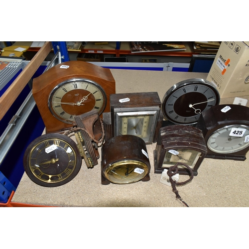 425 - A GROUP OF CLOCKS, comprising four 1930's Smith Sectric clocks, a Temco Bakelite electric clock by T... 