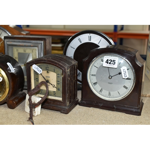 425 - A GROUP OF CLOCKS, comprising four 1930's Smith Sectric clocks, a Temco Bakelite electric clock by T... 