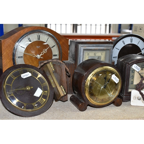 425 - A GROUP OF CLOCKS, comprising four 1930's Smith Sectric clocks, a Temco Bakelite electric clock by T... 