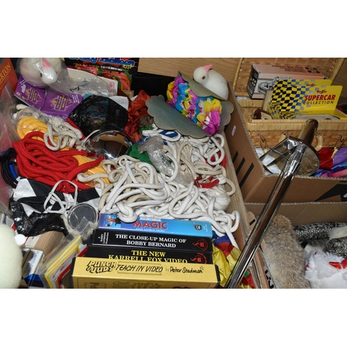 438 - FIVE BOXES OF MAGICIAN'S PROPS AND EQUIPMENT, to include faux rabbits, snakes, parrot, foam doves, u... 