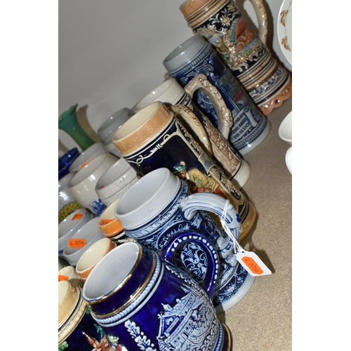 469 - A COLLECTION OF STEINS AND CERAMIC TANKARDS, thirty two pieces to include salt glazed stoneware exam... 