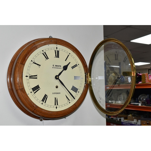 480 - A CIRCULAR WOODEN CASED WALL CLOCK, painted metal dial with black Roman numerals and glass door, cas... 