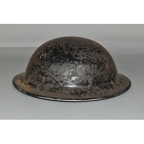 485 - A BRITISH MILITARY STYLE STEEL HELMET, complete with liner and canvas chin strap, distressed black p... 