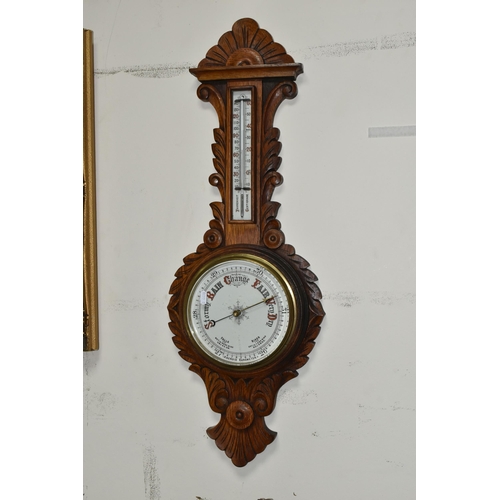 491 - A VICTORIAN OAK CASED ANEROID BAROMETER, heavily carved with a mercury thermometer, height 86cm x wi... 