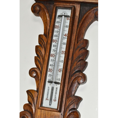 491 - A VICTORIAN OAK CASED ANEROID BAROMETER, heavily carved with a mercury thermometer, height 86cm x wi... 