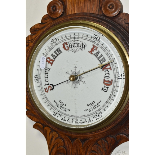 491 - A VICTORIAN OAK CASED ANEROID BAROMETER, heavily carved with a mercury thermometer, height 86cm x wi... 