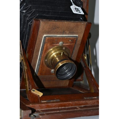 497 - AN O.F.S.ROTHWELL MAHOGANY AND BRASS FIELD CAMERA with a replacement lens plate holding a Busch's Ra... 