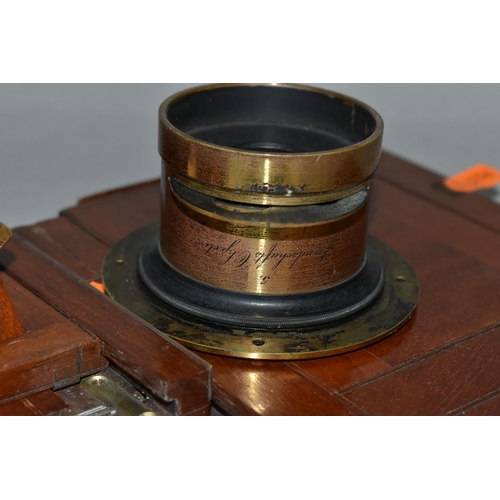 497 - AN O.F.S.ROTHWELL MAHOGANY AND BRASS FIELD CAMERA with a replacement lens plate holding a Busch's Ra... 