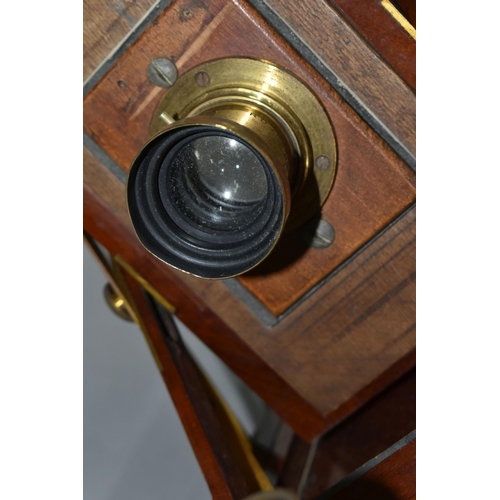 497 - AN O.F.S.ROTHWELL MAHOGANY AND BRASS FIELD CAMERA with a replacement lens plate holding a Busch's Ra... 