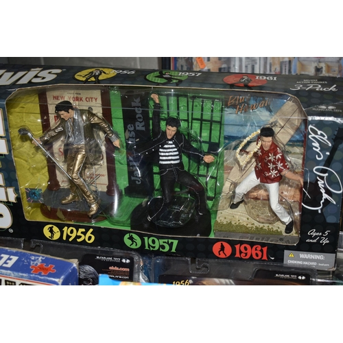 554 - TWO BOXES OF ELVIS PRESLEY MEMORABILIA ETC, to include a boxed set of three action figures, six sing... 