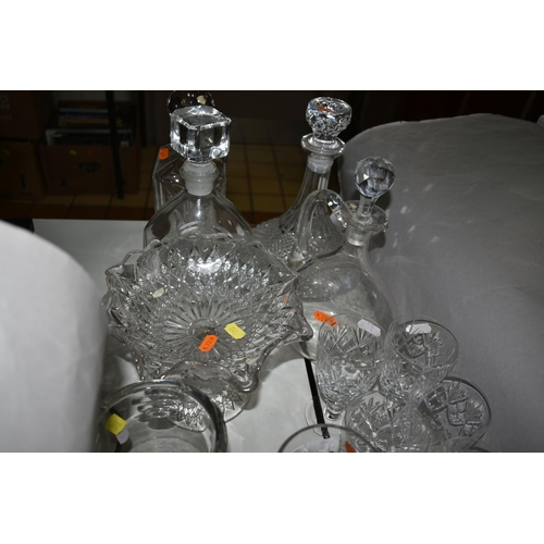 592 - A GROUP OF CUT GLASS DECANTERS AND WATERFORD CRYSTAL, comprising a Waterford Crystal mantel clock, a... 