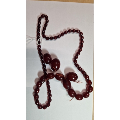 27 - A GRADUATED BAKELITE BEAD NECKLACE, comprising of sixty-nine beads measuring approximately 9mm to 29... 