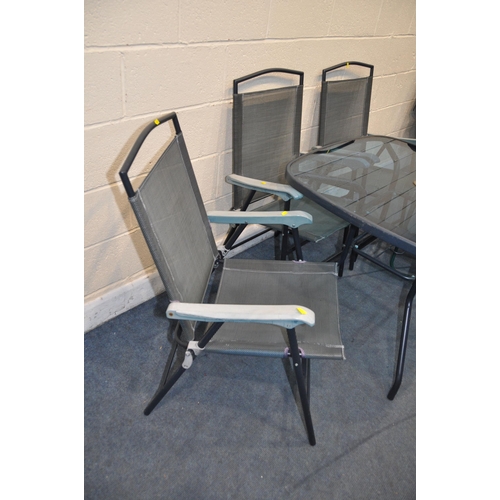 1115 - A HOMEBASE GLASS TOPPED GARDEN TABLE with three matching chairs and two other folding chairs