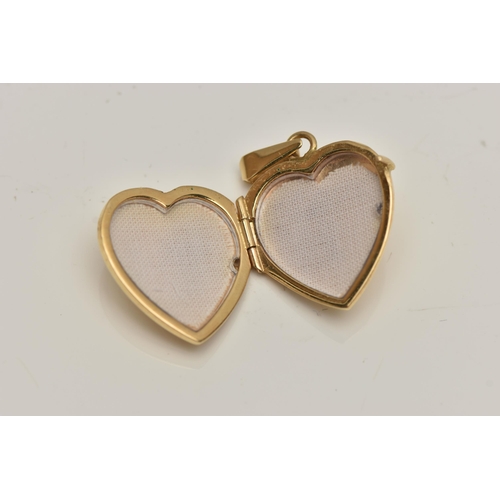 15 - A HEART SHAPED LOCKET, engraved with foliate detail to the front, suspension loop stamped 750, lengt... 