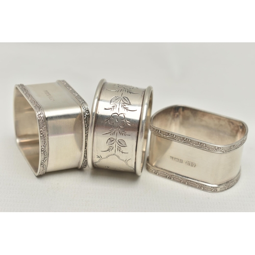 151 - A PAIR OF ELIZABETH II RECTANGULAR SILVER NAPKIN RINGS AND A CIRCULAR NAPKIN RING, the pair with rim... 