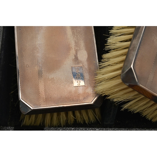 162 - TWO MID 20TH CENTURY CASED SILVER MOUNTED BRUSH AND COMB SETS, comprising a case containing a pair o... 