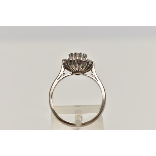 2 - A MODERN DIAMOND CLUSTER RING, a principle round brilliant cut diamond prong set in white metal, wit... 