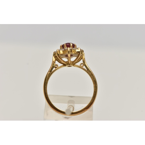 3 - A MODERN RUBY AND DIAMOND CLUSTER RING, a principle oval cut ruby, approximate length 7mm x width 5.... 